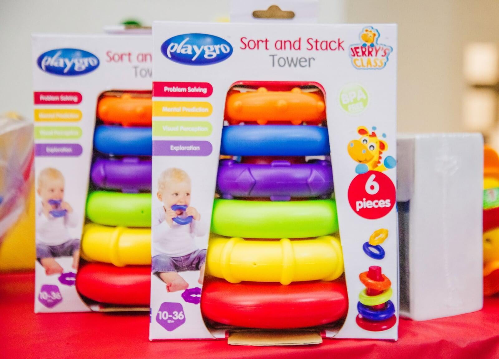 Two rainbow colored infant stacking toys.