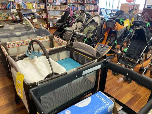 Pack and Plays and other baby equipment for sale on a basketball court